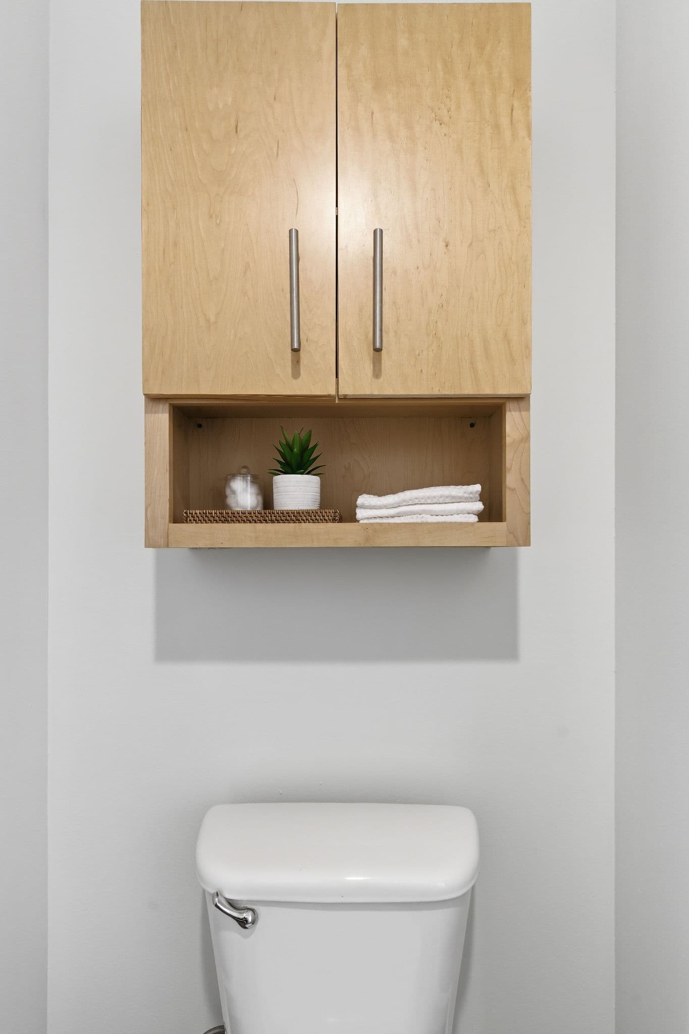 Maple bathroom storage cabinet with newly painted surrounding walls