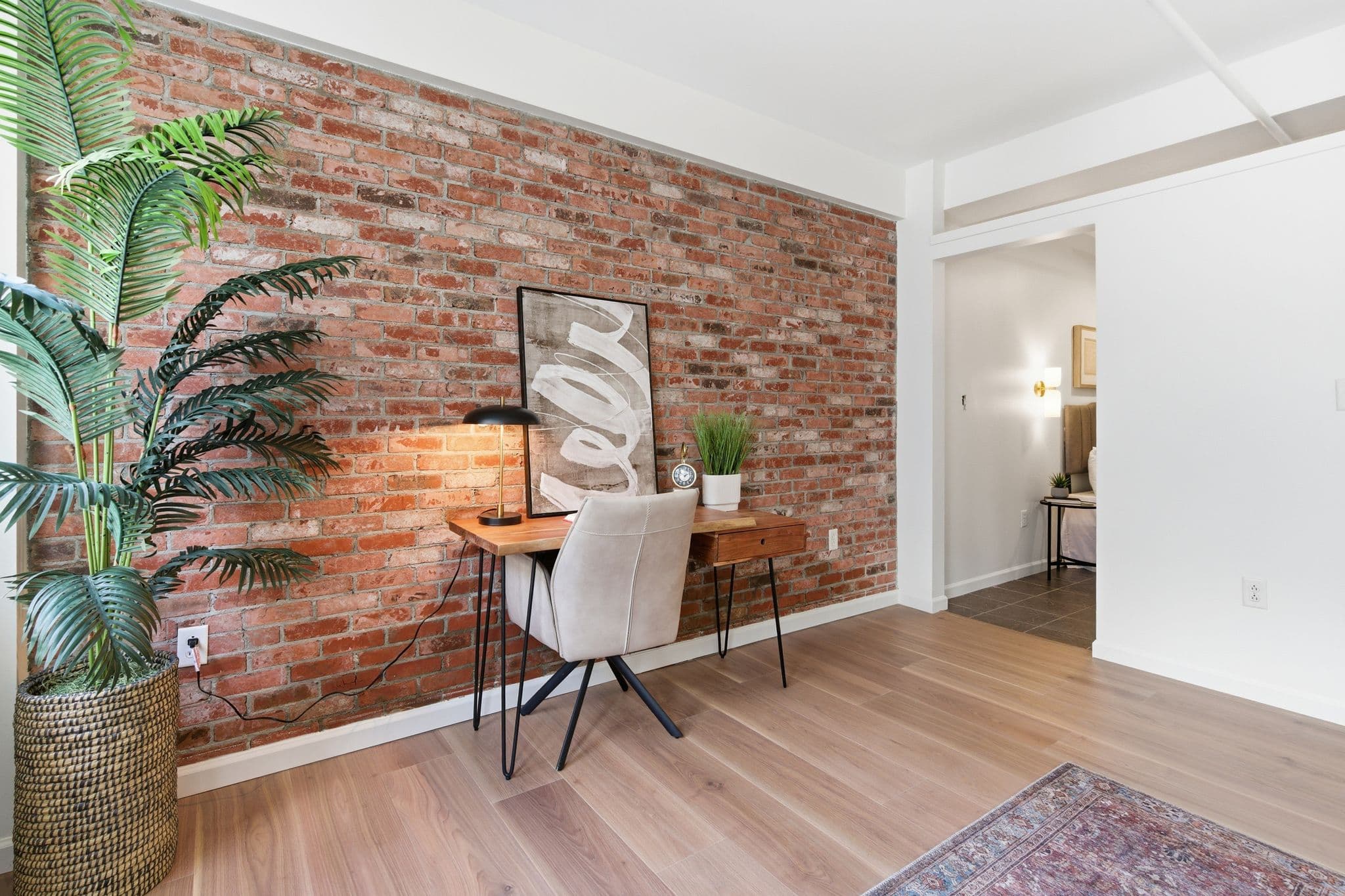 Home office with brick wall and painted doorway transition, Nashville loft