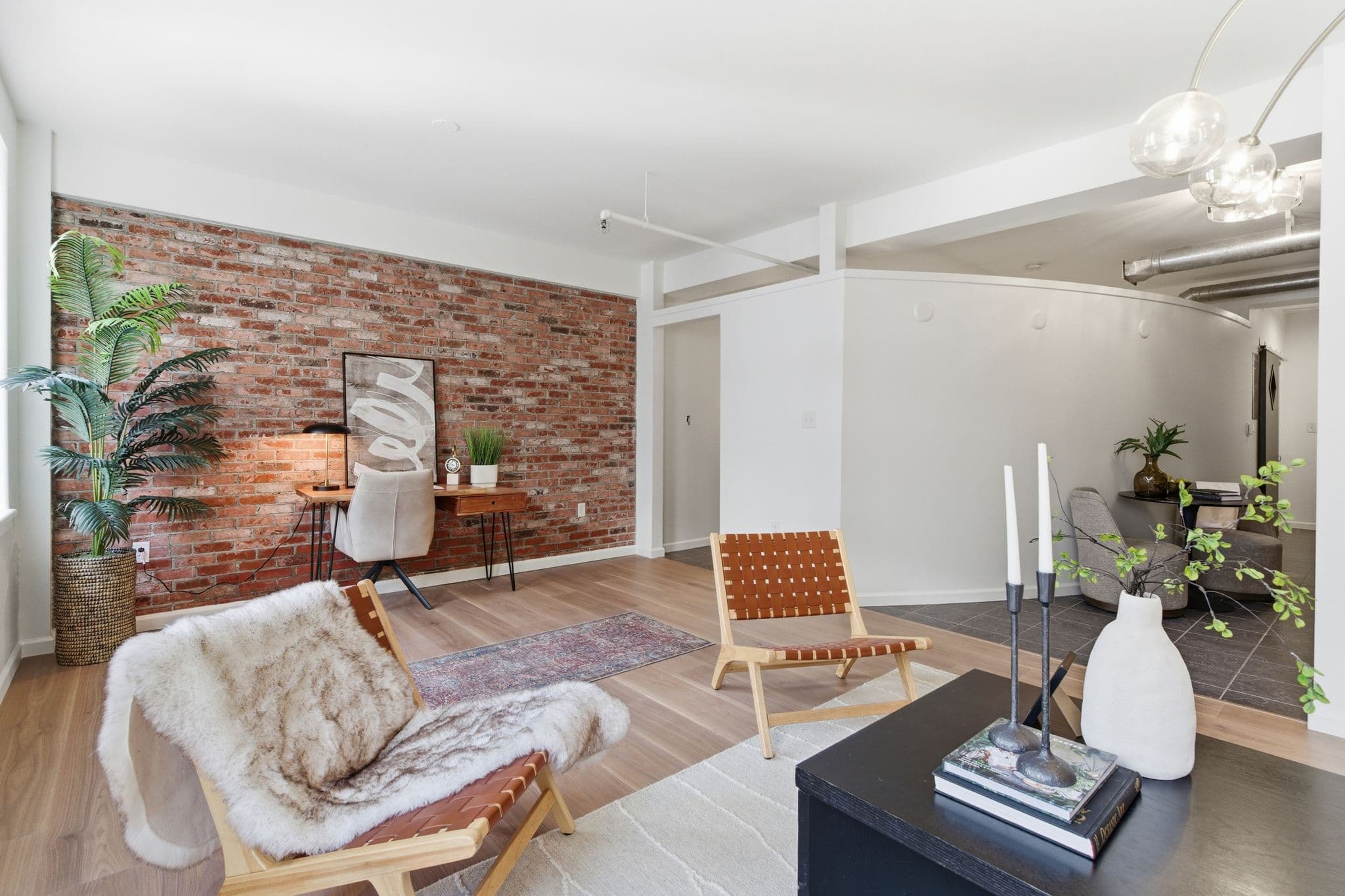 Home office area with exposed brick wall and freshly painted trim, Nashville loft