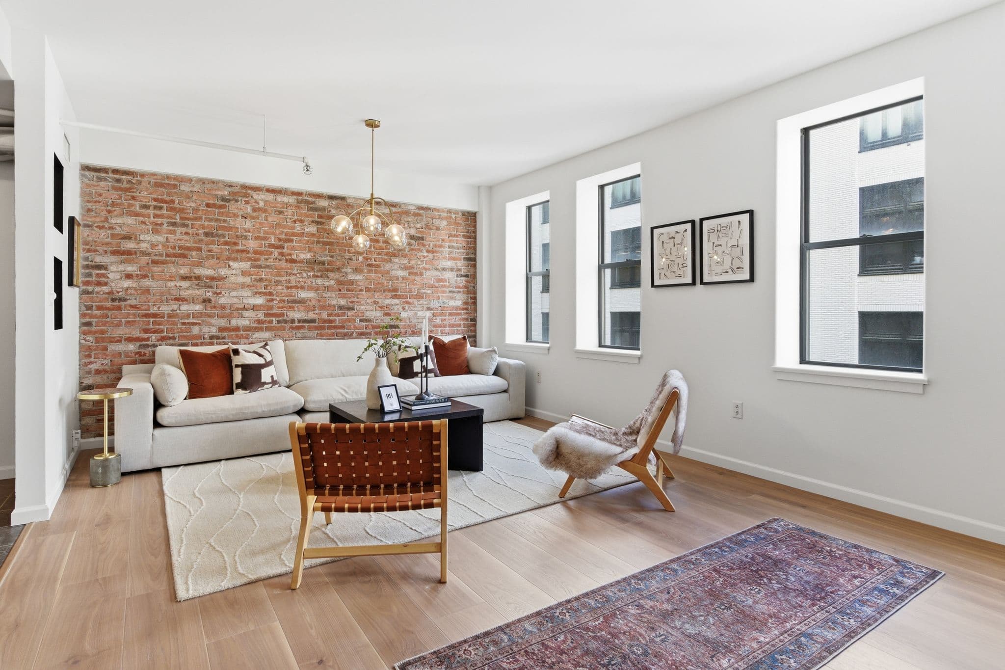Loft living room with painted accent walls and exposed brick by Nashville painters Walsh Painting