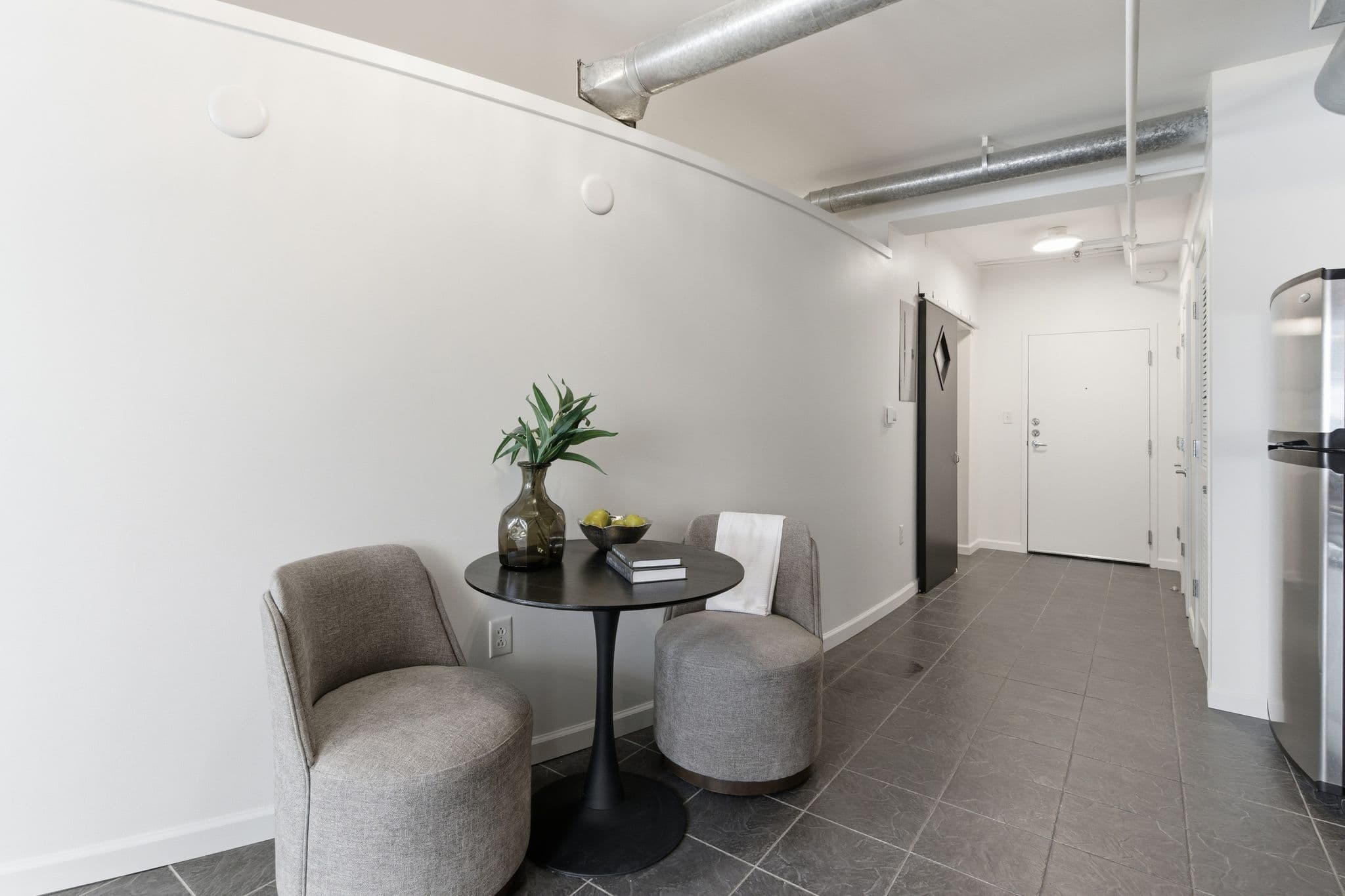 Small seating nook with two chairs and freshly painted white walls